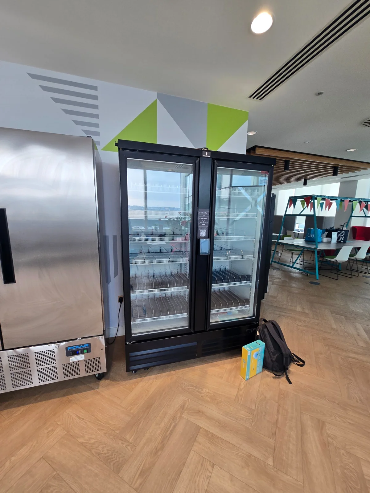 New double-door smart cooler installed in a customer refreshment area